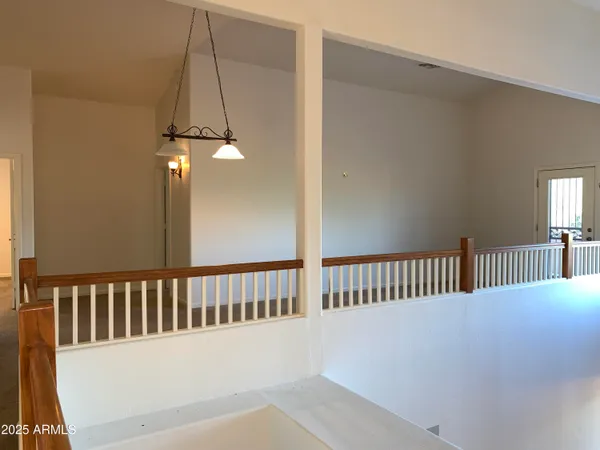 a view of a balcony with a yard