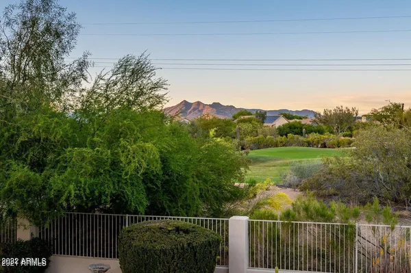 a view of a house with a swimming pool and a yard