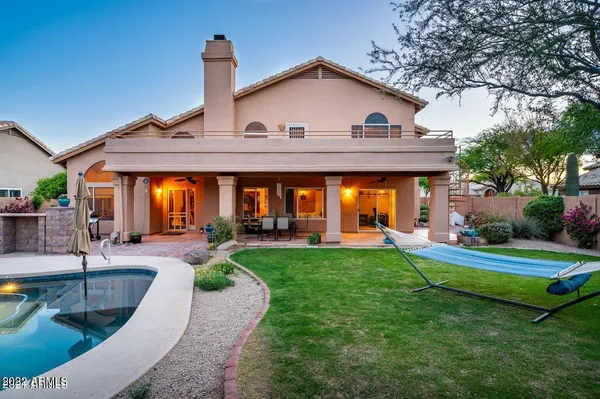a view of backyard with outdoor seating and plants