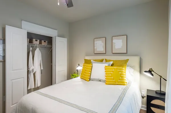 a bedroom with a bed and wooden floor