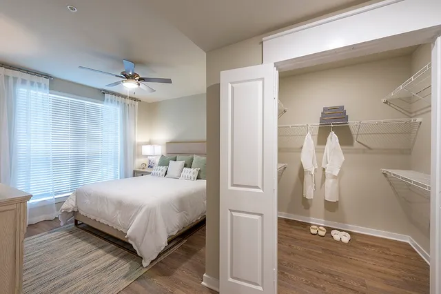 a bedroom with a bed and a mirror