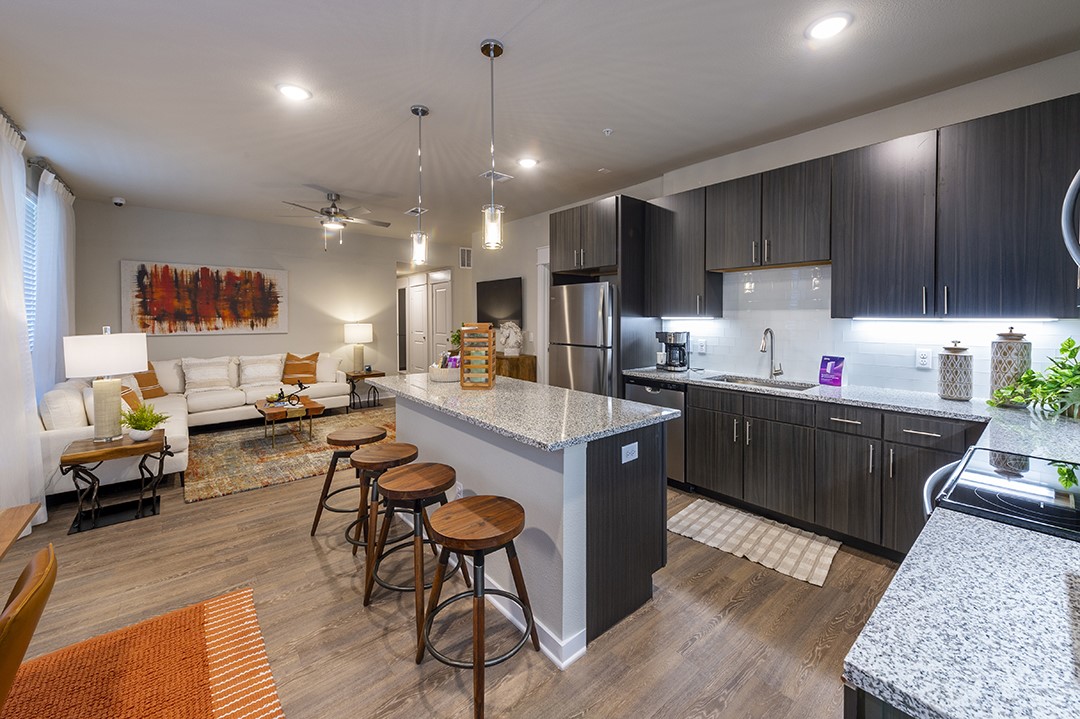 30020 Creekside Ter Drive, Unit 2114 Spring, TX 77386 - Photo 6 of 23 a kitchen with a table chairs refrigerator and microwave