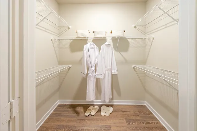 a view of walk in closet with empty racks