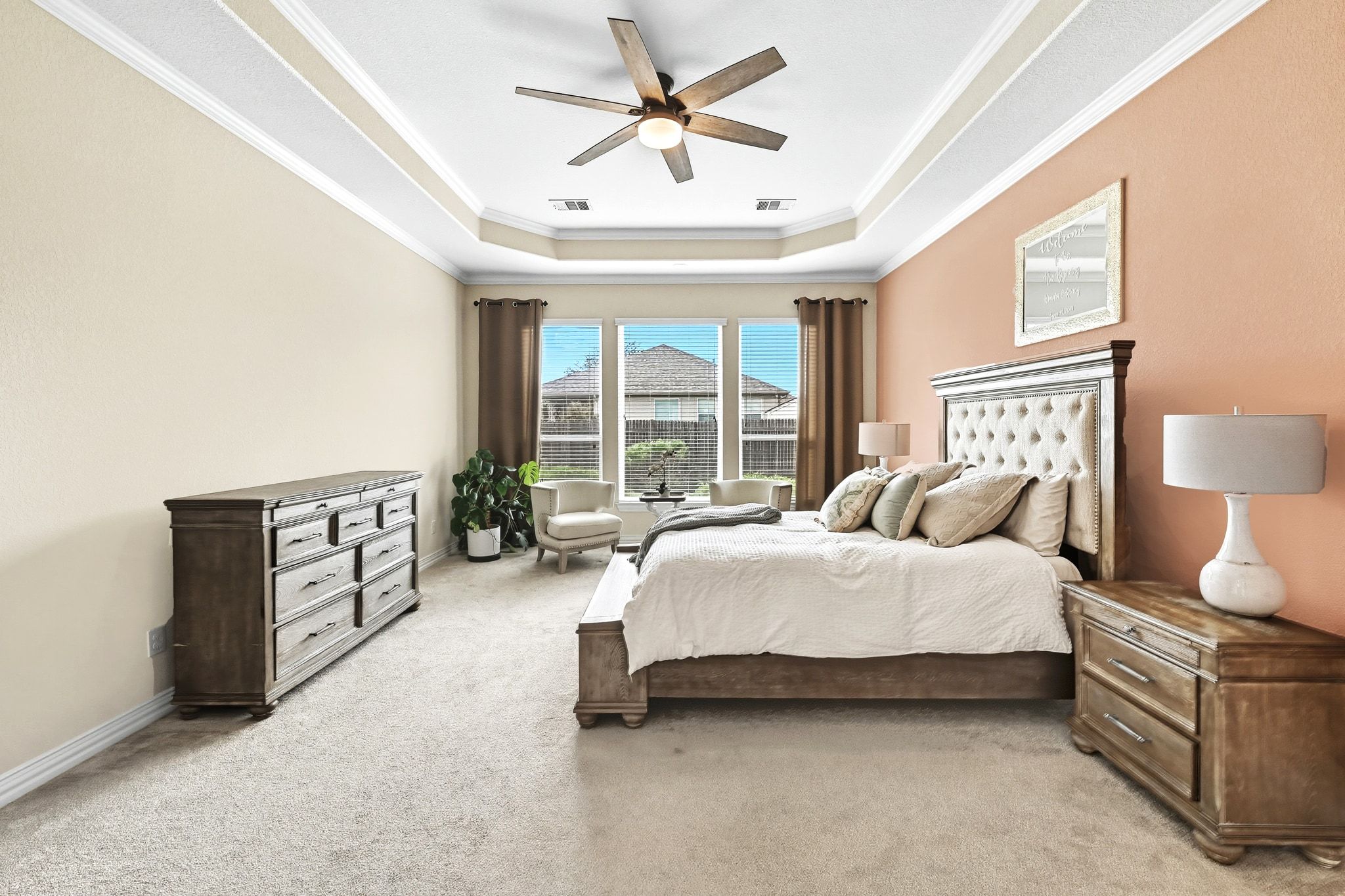 19620 Stanton Drew Pflugerville, TX 78660 - Photo 16 of 33 Bedroom with crown molding, a tray ceiling, a ceiling fan, and light colored carpet