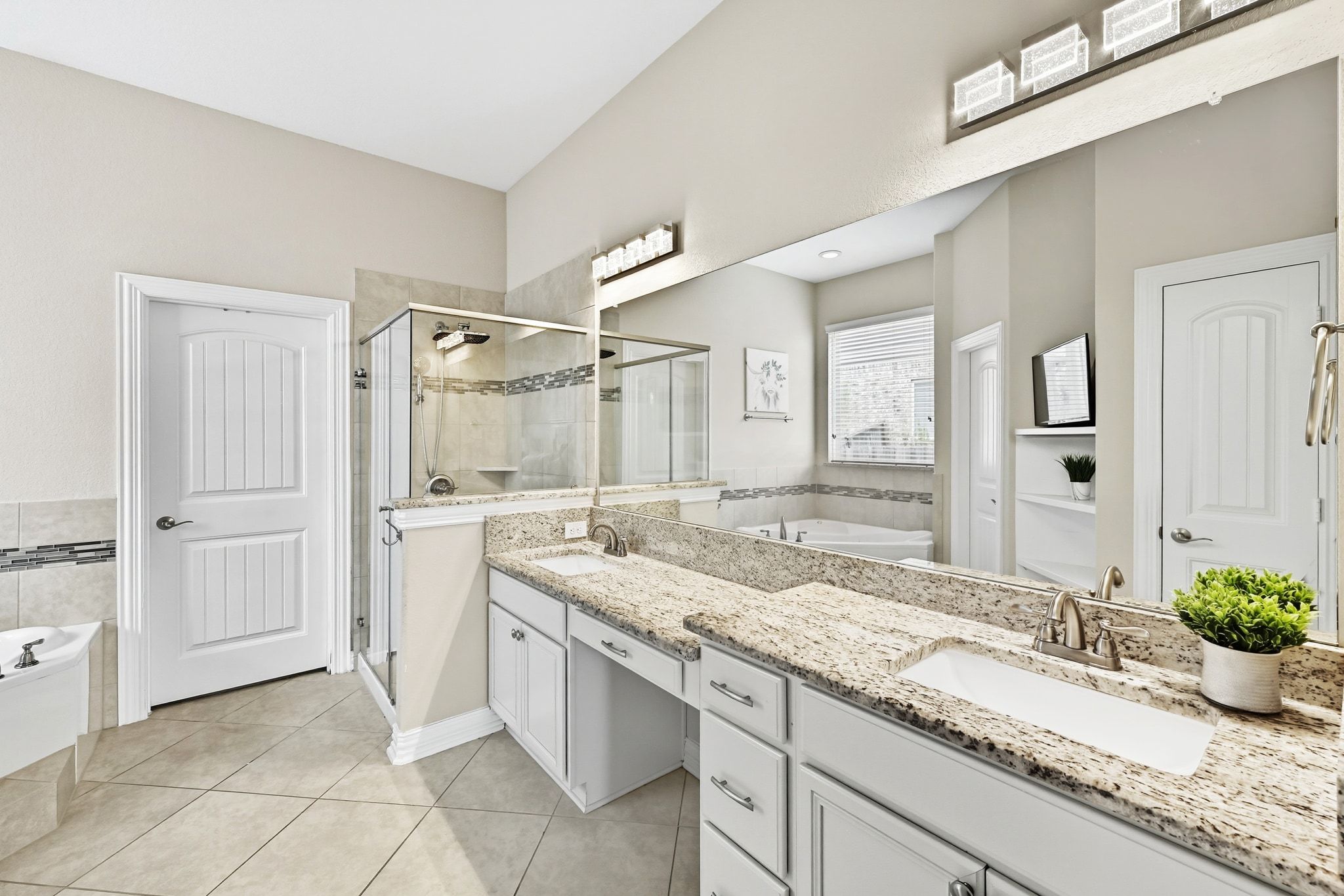 19620 Stanton Drew Pflugerville, TX 78660 - Photo 17 of 33 Full bath with a garden tub, double vanity, a shower stall, and light tile patterned floors