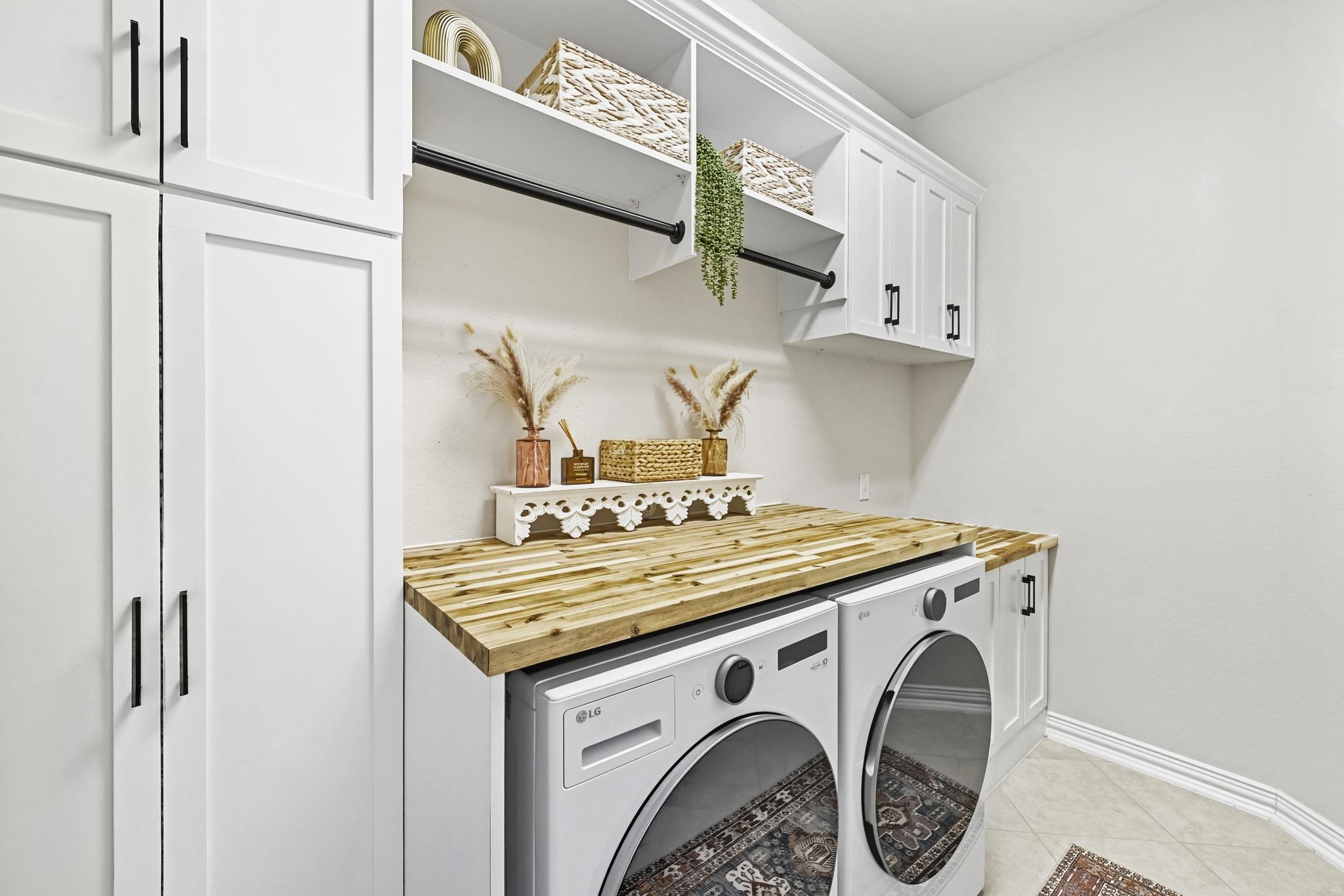 19620 Stanton Drew Pflugerville, TX 78660 - Photo 24 of 33 Laundry area featuring light tile patterned floors, cabinet space, and independent washer and dryer