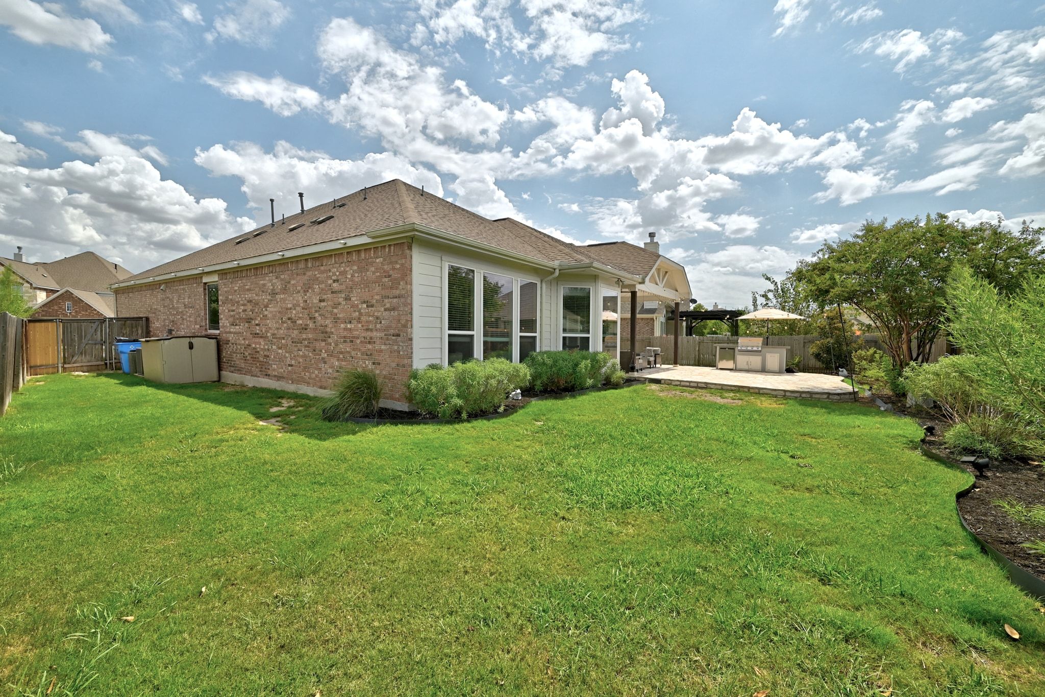 19620 Stanton Drew Pflugerville, TX 78660 - Photo 26 of 33 Rear view of house with a fenced backyard, a patio area, and brick siding