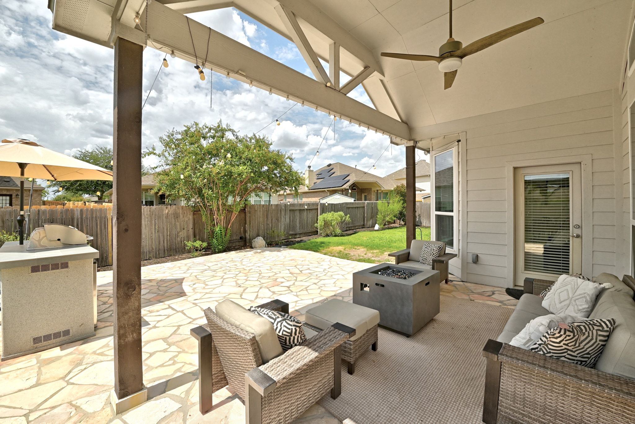 19620 Stanton Drew Pflugerville, TX 78660 - Photo 28 of 33 Fenced backyard featuring a patio area, a ceiling fan, and an outdoor living space with a fire pit