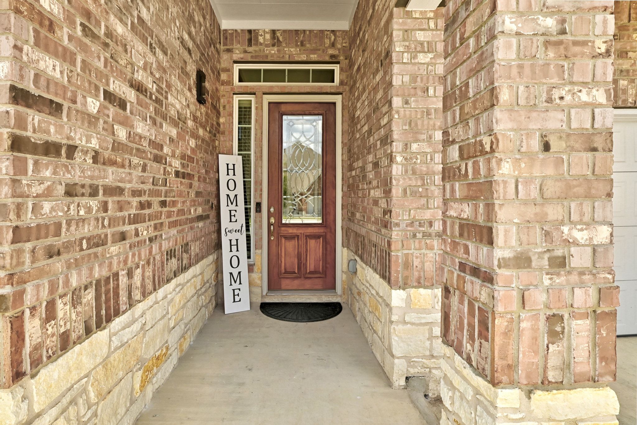 19620 Stanton Drew Pflugerville, TX 78660 - Photo 3 of 33 Doorway to property featuring brick siding and covered porch