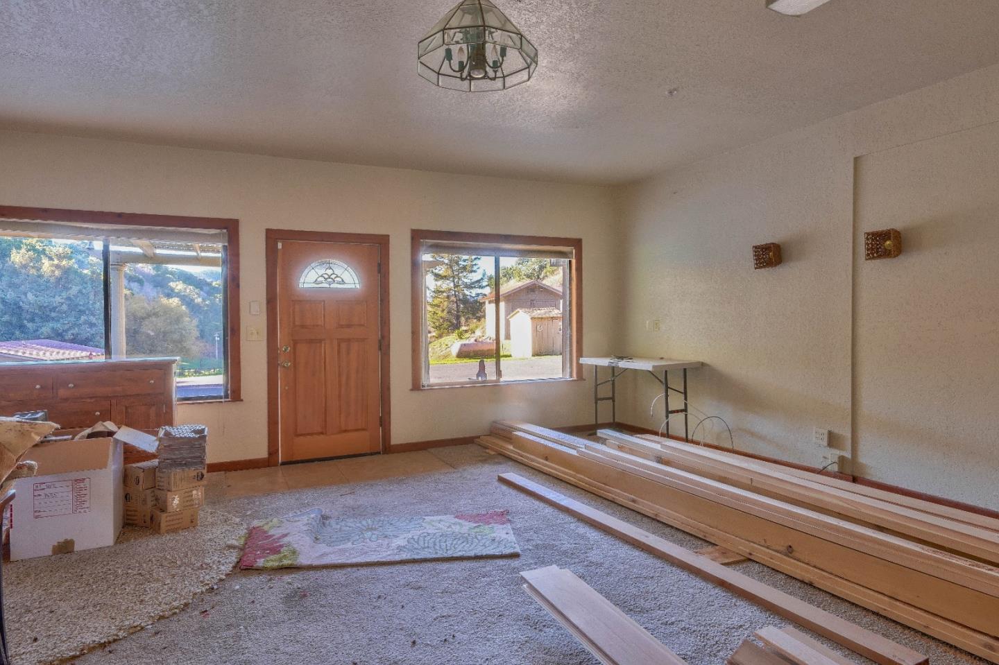 384 Corral De Tierra Road Salinas, CA 93908 - Photo 7 of 31 a living room with furniture and a floor to ceiling window
