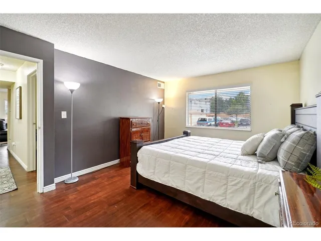 a bedroom with a bed and a large mirror