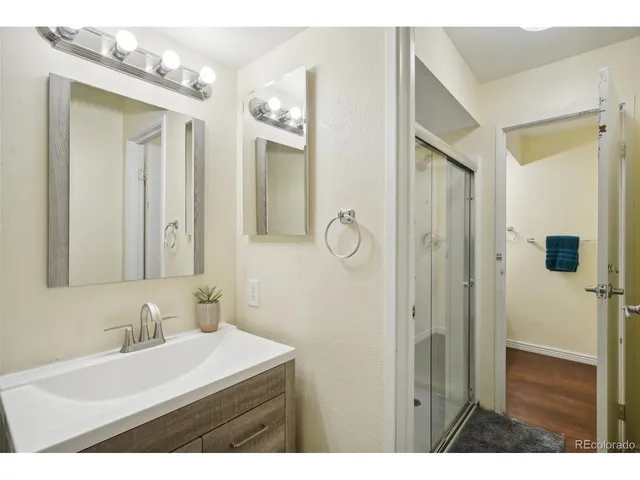 a bathroom with a sink a mirror and shower