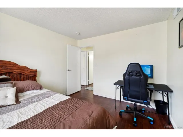 a bedroom with a bed and a chair