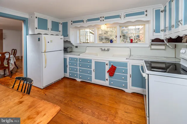 a kitchen with refrigerator and window