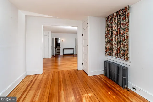 a view of a room with wooden floor and staircase
