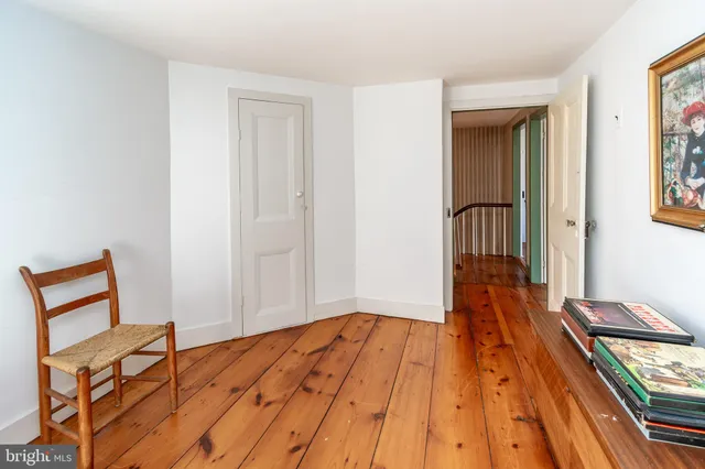 a view of a bedroom with wooden floor and stairs