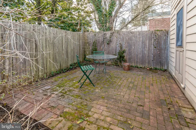 a backyard of a house with table and chairs
