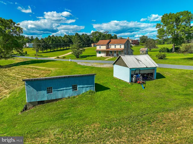 an aerial view of a house with a garden and swimming pool