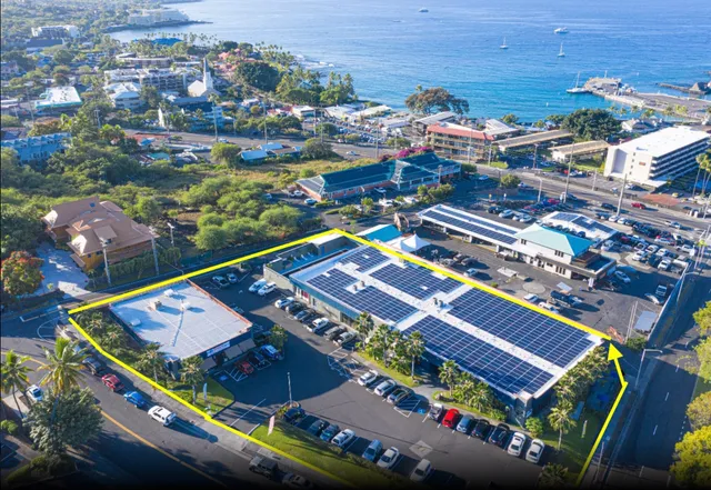 an aerial view of a tennis ground and a residential houses