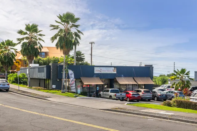 a view of a swimming pool with a table and chairs under an umbrella