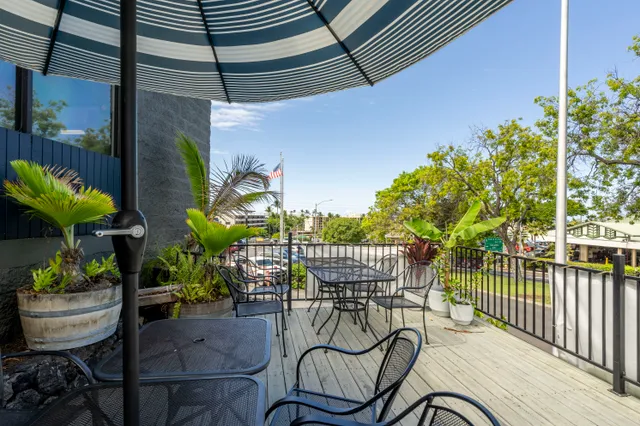 an aerial view of a house with a yard basket ball court and outdoor seating
