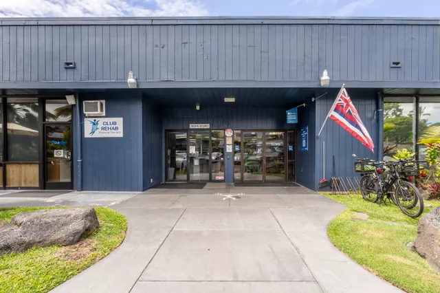 a front view of a house with a yard and potted plant