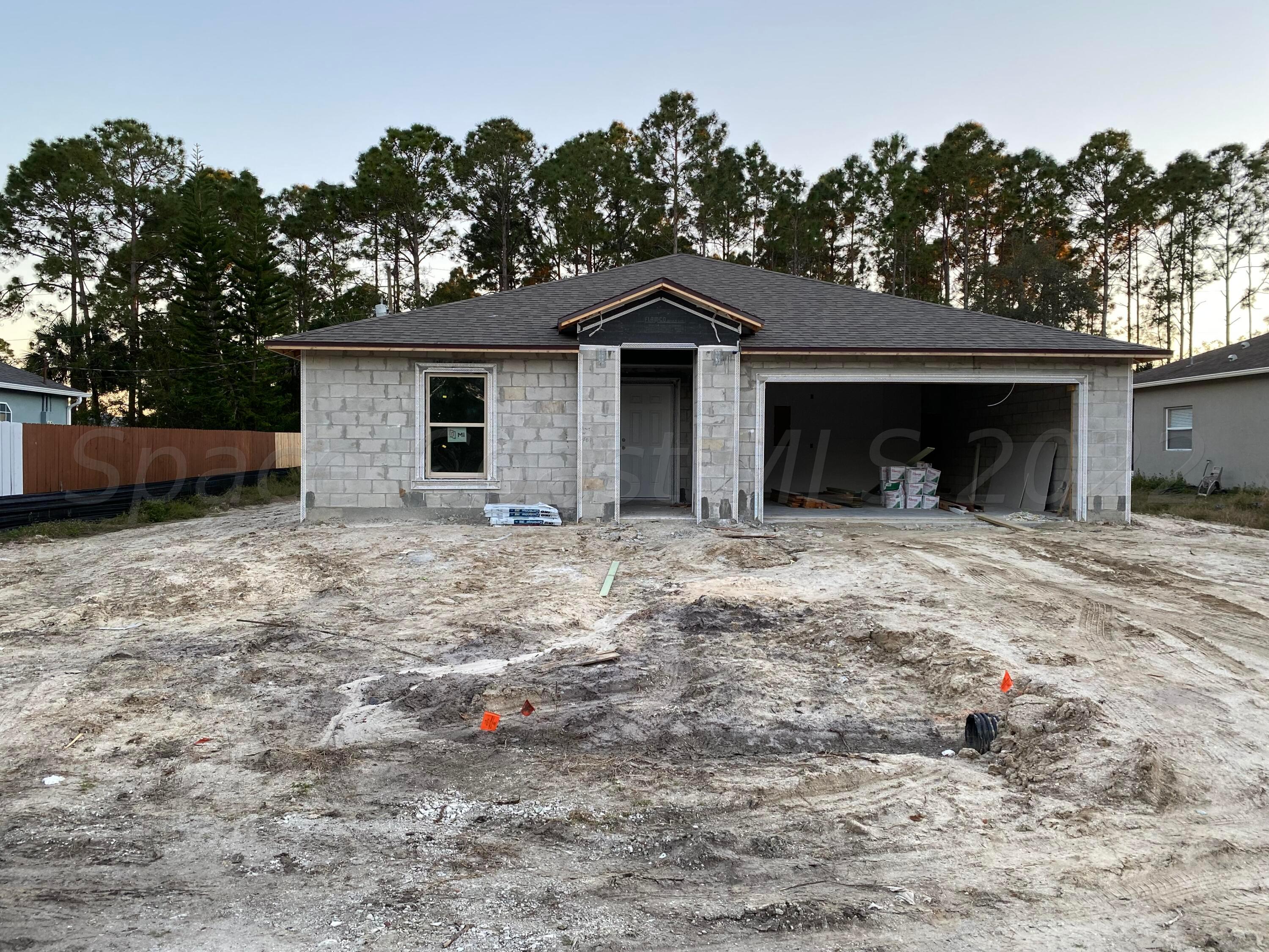 1738 Hydrangea Road Palm Bay, FL 32907 - Photo 1 of 20 a view of a house with a yard and a tree