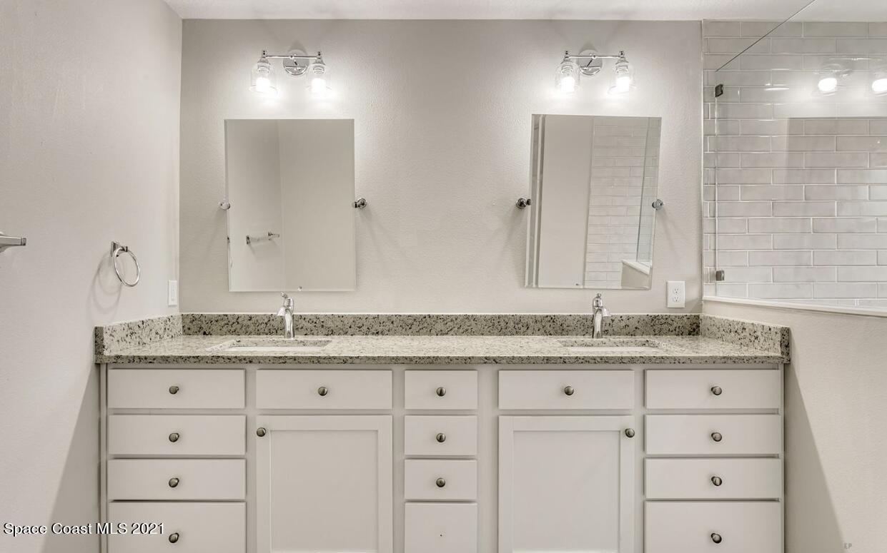 1738 Hydrangea Road Palm Bay, FL 32907 - Photo 18 of 20 a bathroom with a granite countertop sink mirror and double
