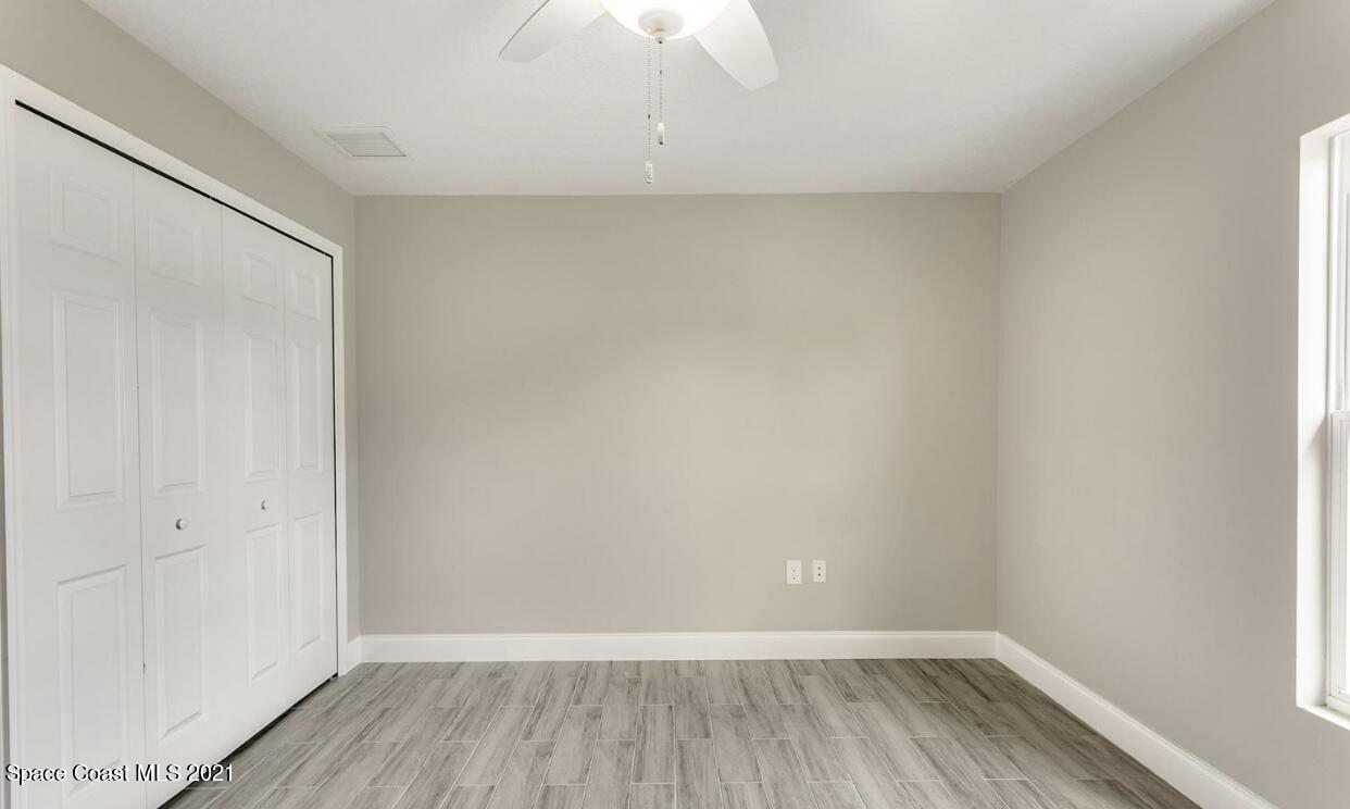 1738 Hydrangea Road Palm Bay, FL 32907 - Photo 5 of 20 a view of an empty room with wooden floor