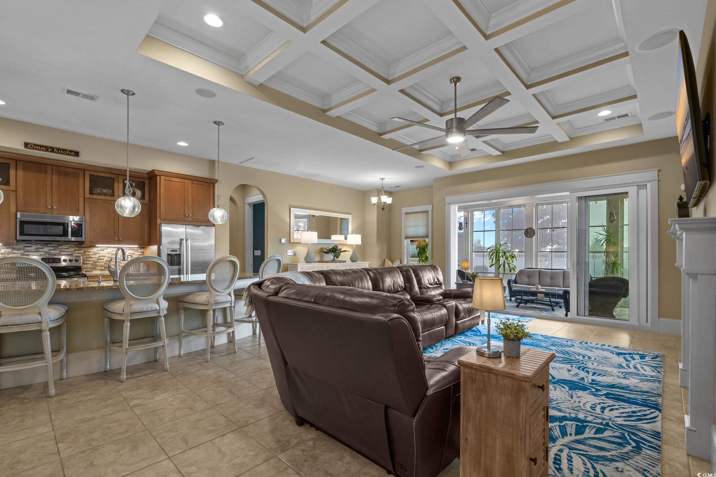 2604 Painted Trillium Court Myrtle Beach, SC 29579 - Photo 14 of 40 Living area featuring a ceiling fan, coffered ceiling, a chandelier, arched walkways, and beamed ceiling