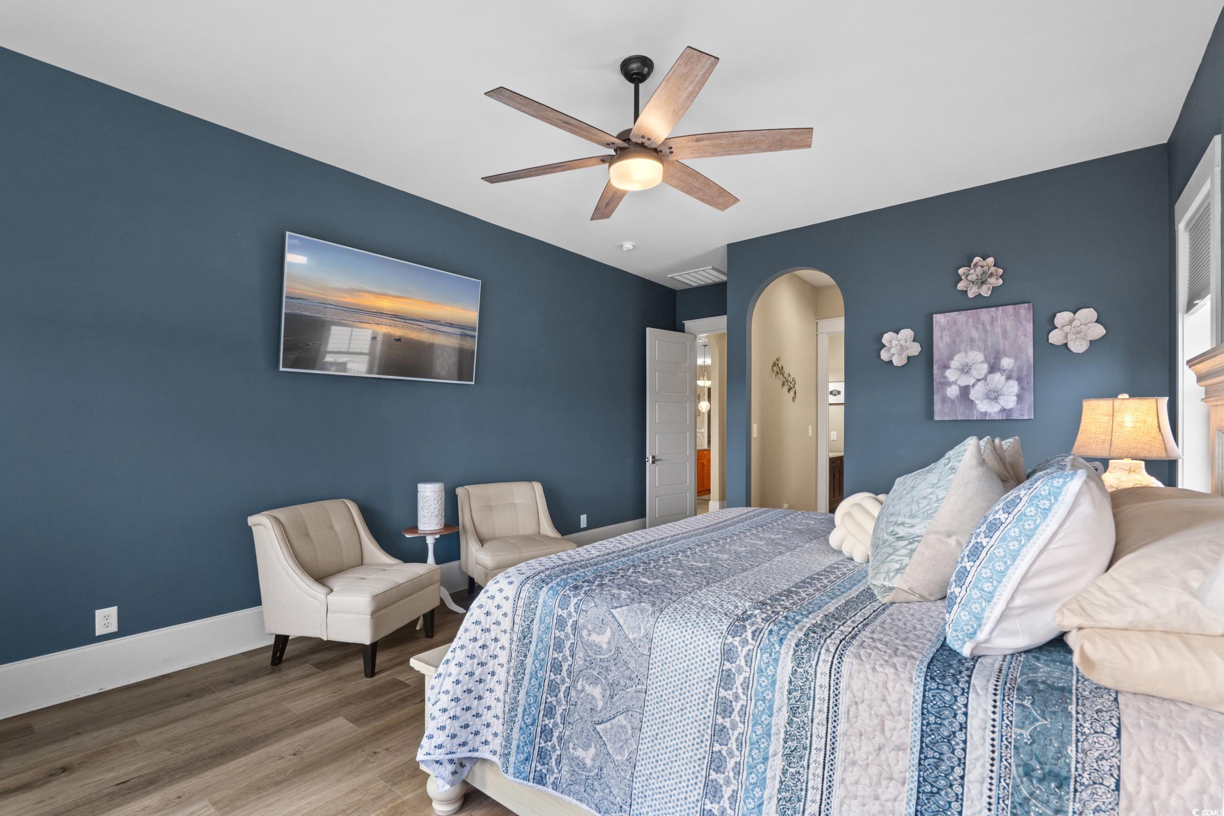 2604 Painted Trillium Court Myrtle Beach, SC 29579 - Photo 17 of 40 Bedroom with ceiling fan, arched walkways, and wood finished floors