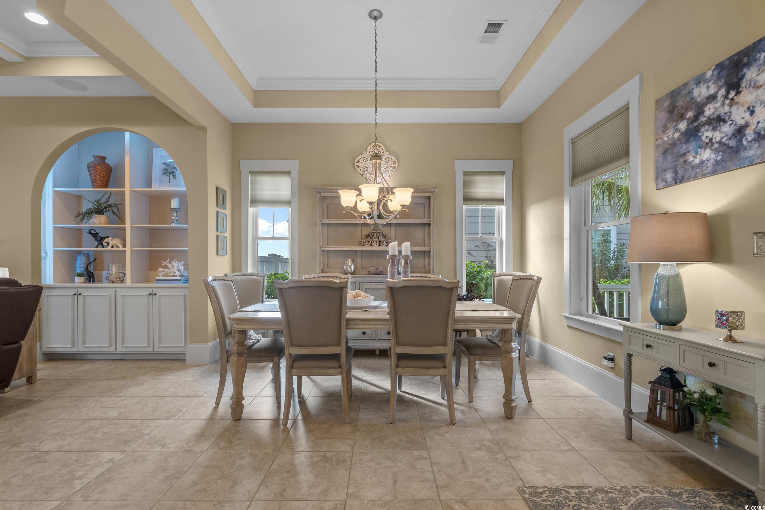2604 Painted Trillium Court Myrtle Beach, SC 29579 - Photo 6 of 40 Dining room with crown molding, a chandelier, built in features, and light tile patterned floors
