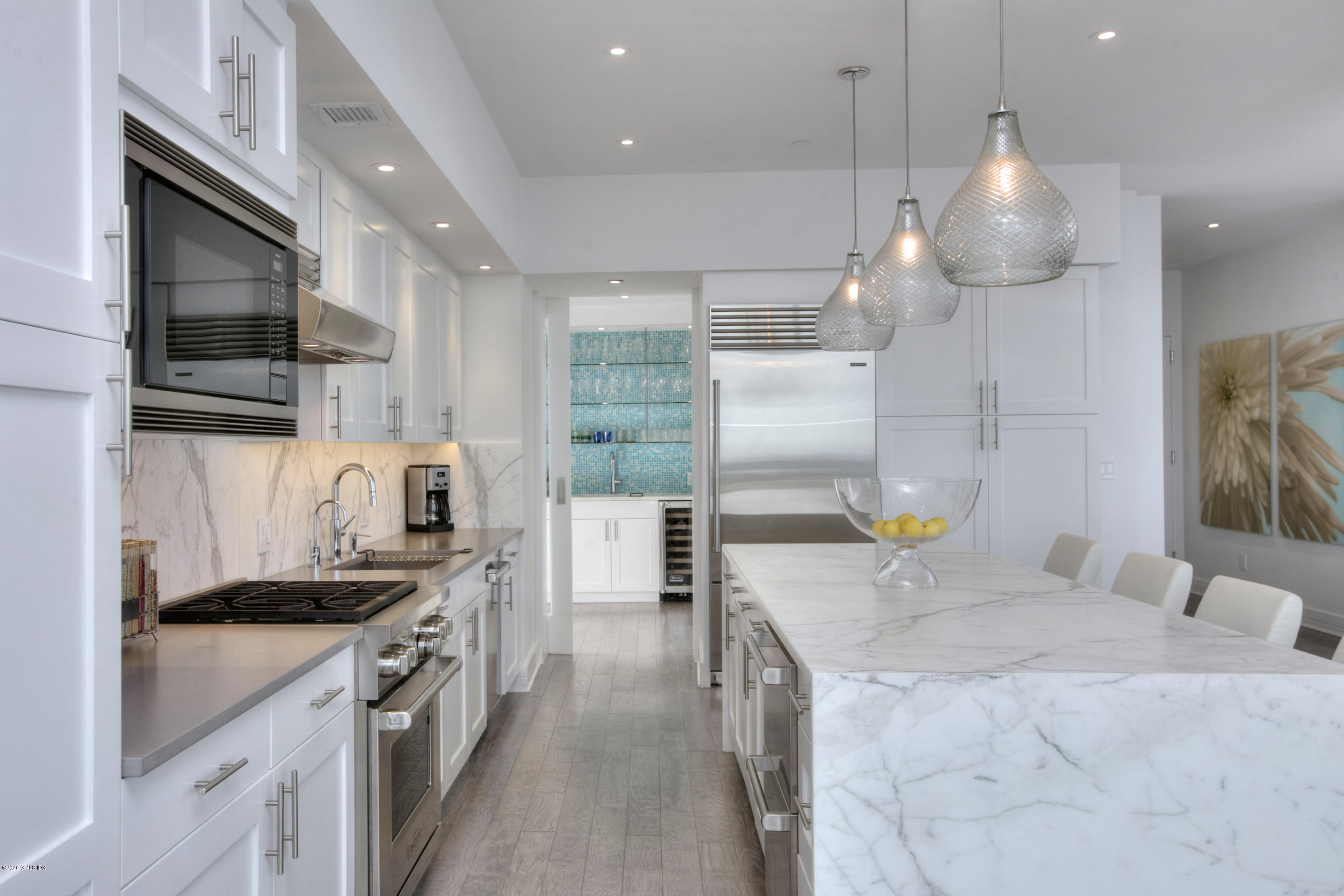 1 Broad Street, Unit PHD4 Stamford, CT 06901 - Photo 11 of 38 a kitchen with kitchen island granite countertop a sink stainless steel appliances and cabinets