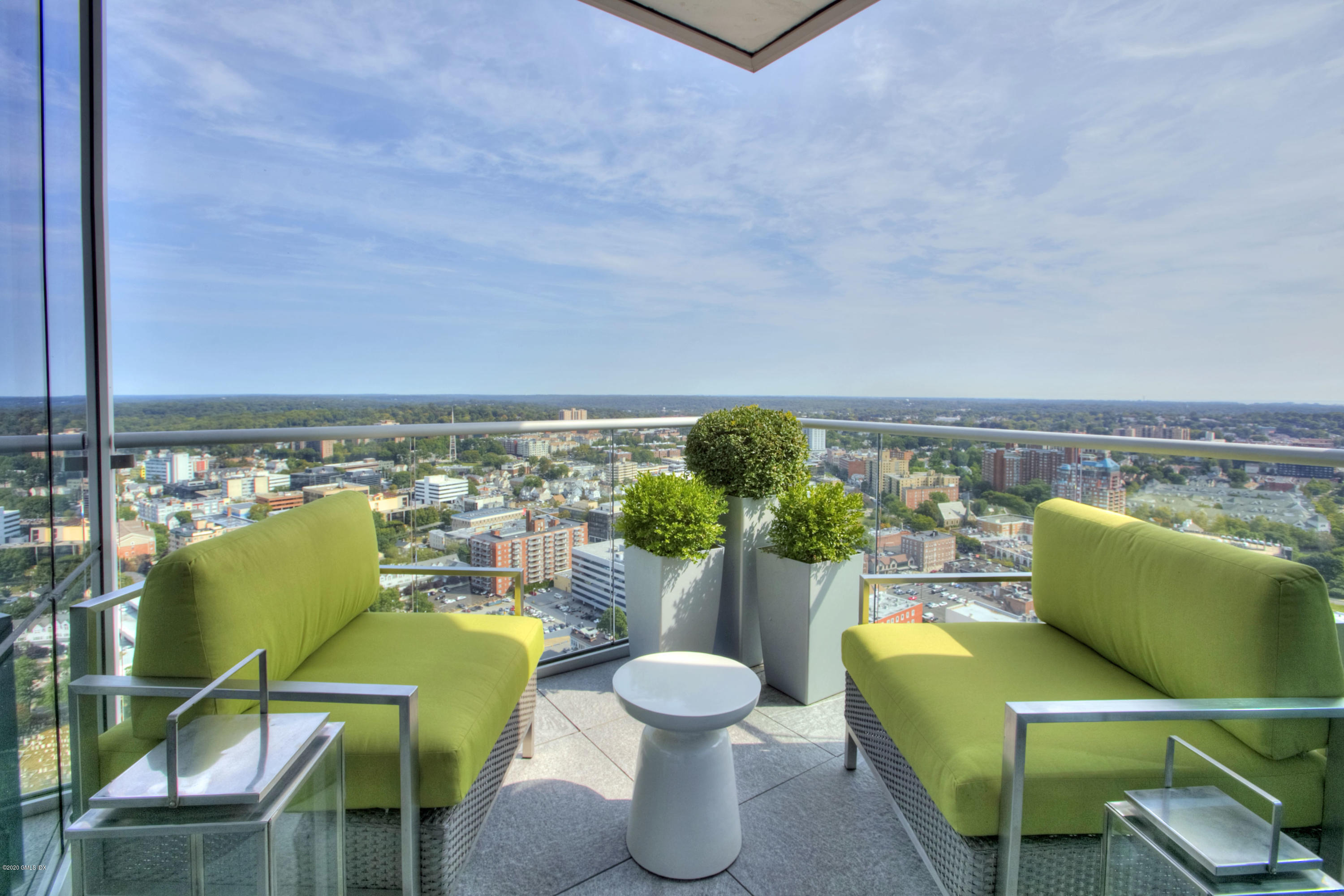 1 Broad Street, Unit PHD4 Stamford, CT 06901 - Photo 22 of 38 a view of a balcony with chairs and a potted plant