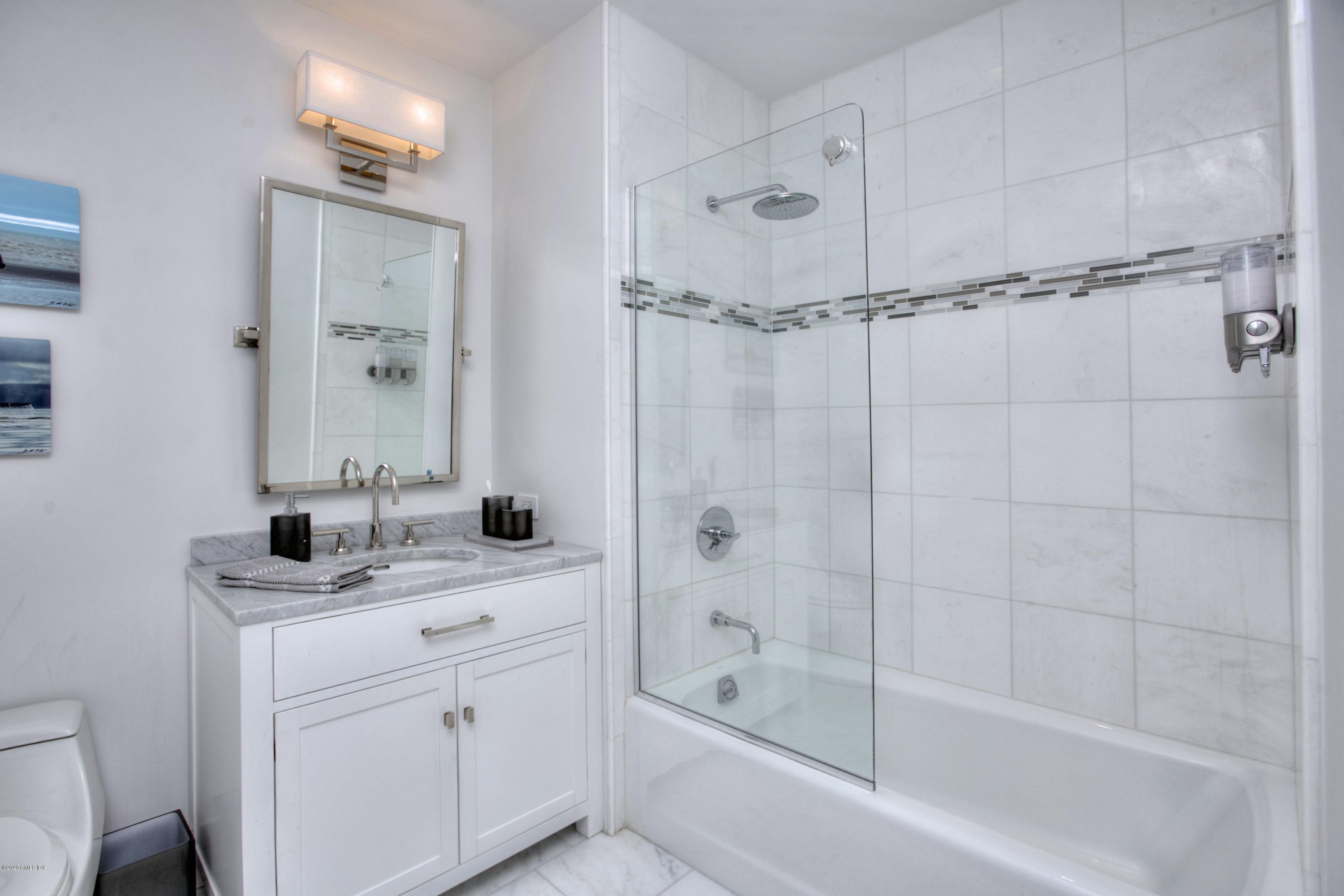 1 Broad Street, Unit PHD4 Stamford, CT 06901 - Photo 25 of 38 a bathroom with a granite countertop sink a mirror a bathtub and shower