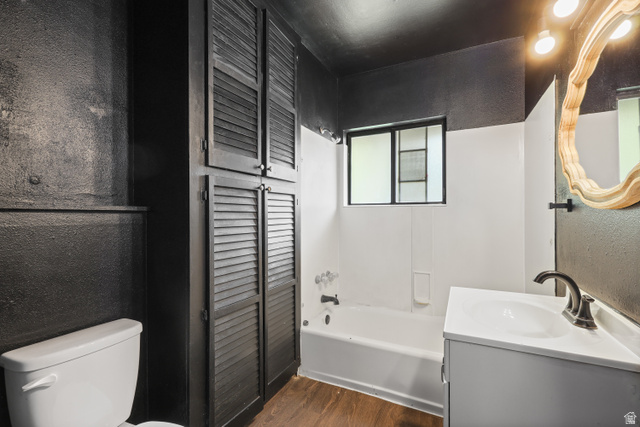 2576 Gramercy Avenue Ogden, UT 84401 - Photo 13 of 20 Full bath featuring a textured wall, vanity, dark wood-style floors, a closet, and shower / tub combination