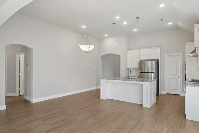a view of kitchen with sink refrigerator and wooden floor