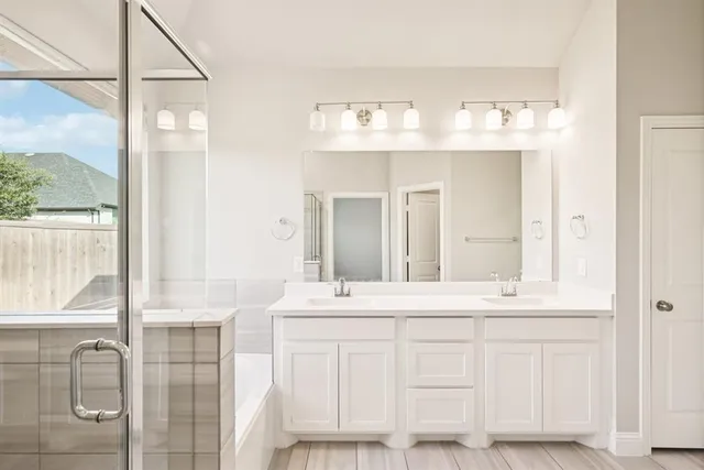 a bathroom with a double vanity sink and a mirror