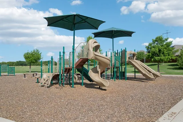 a childrens park with lots of swings and slides