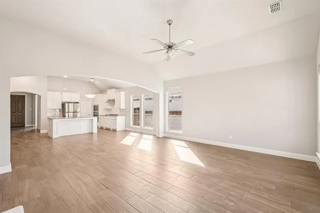 a view of a kitchen with wooden floor and a kitchen