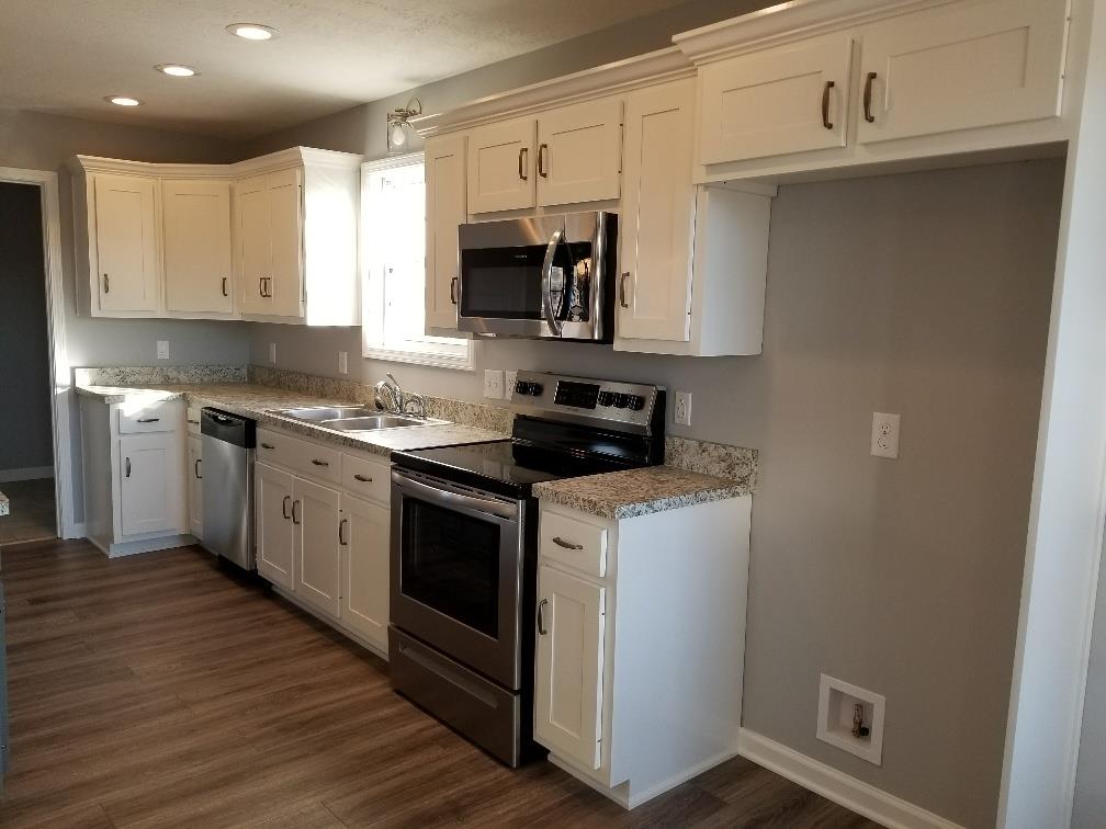 1680 Rock Bridge Road Bethpage, TN 37022 - Photo 11 of 19 a kitchen with stainless steel appliances granite countertop a stove a sink and a microwave