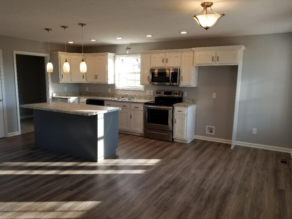 1680 Rock Bridge Road Bethpage, TN 37022 - Photo 12 of 19 a kitchen with stainless steel appliances granite countertop a sink a stove and a refrigerator