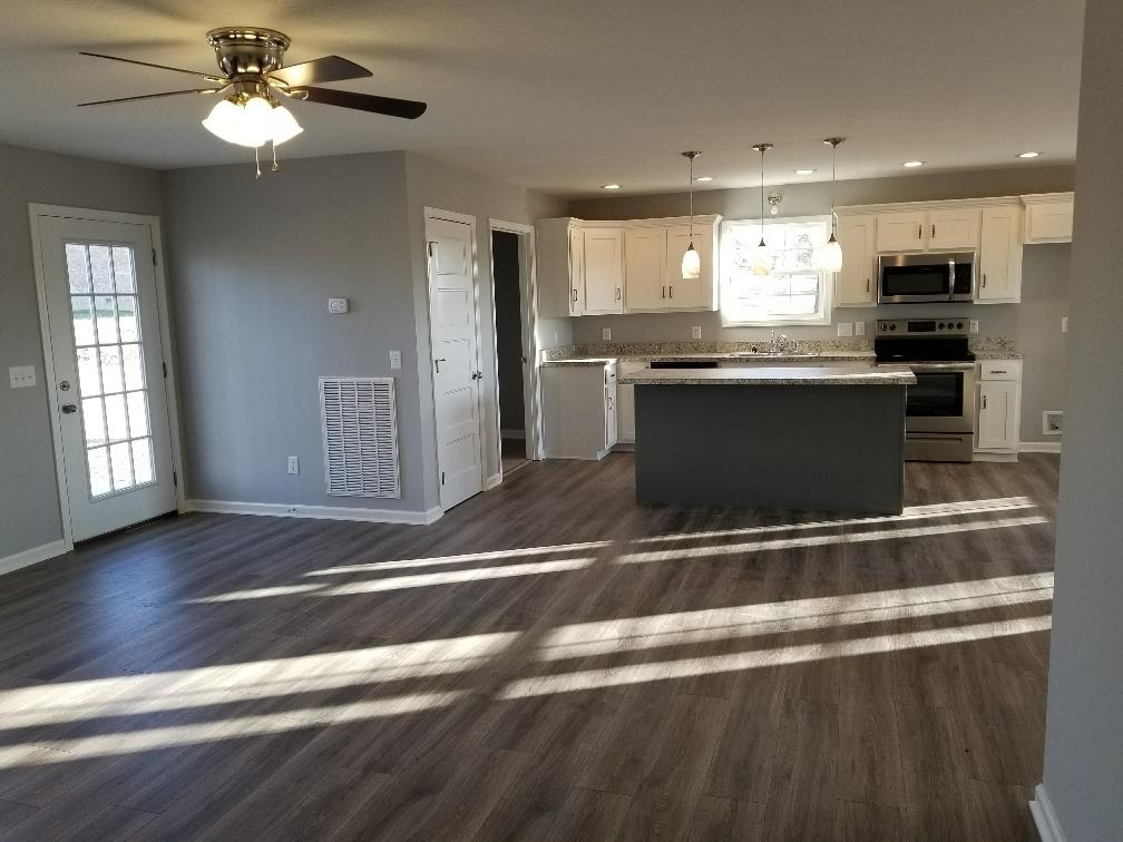 1680 Rock Bridge Road Bethpage, TN 37022 - Photo 8 of 19 a kitchen with kitchen island granite countertop stainless steel appliances and wooden cabinets