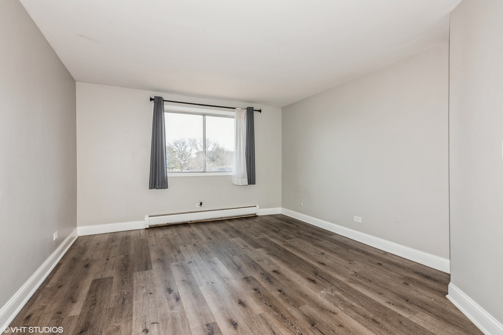 255 North Mill Road, Unit 7B Addison, IL 60101 - Photo 14 of 19 an empty room with wooden floor and windows