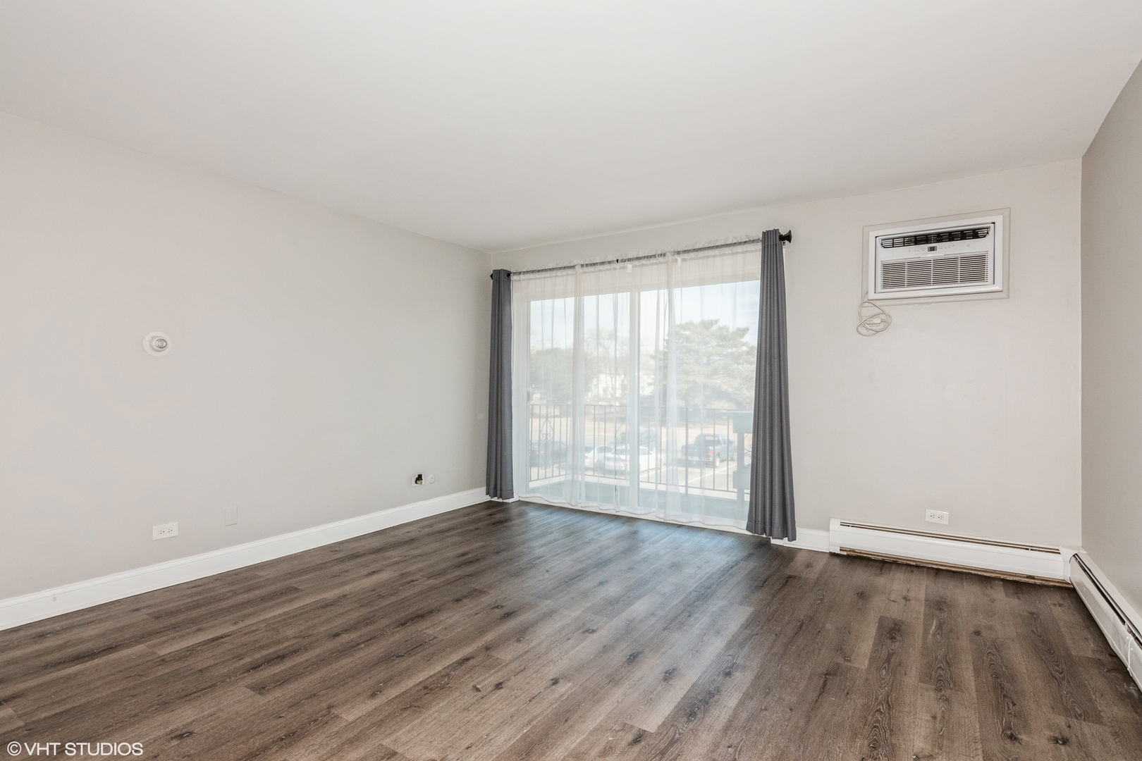 255 North Mill Road, Unit 7B Addison, IL 60101 - Photo 3 of 19 an empty room with wooden floor and windows
