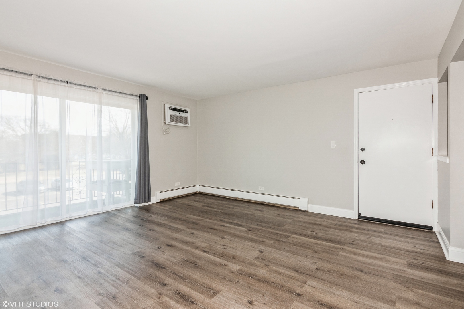 255 North Mill Road, Unit 7B Addison, IL 60101 - Photo 4 of 19 a view of an empty room with wooden floor and a window