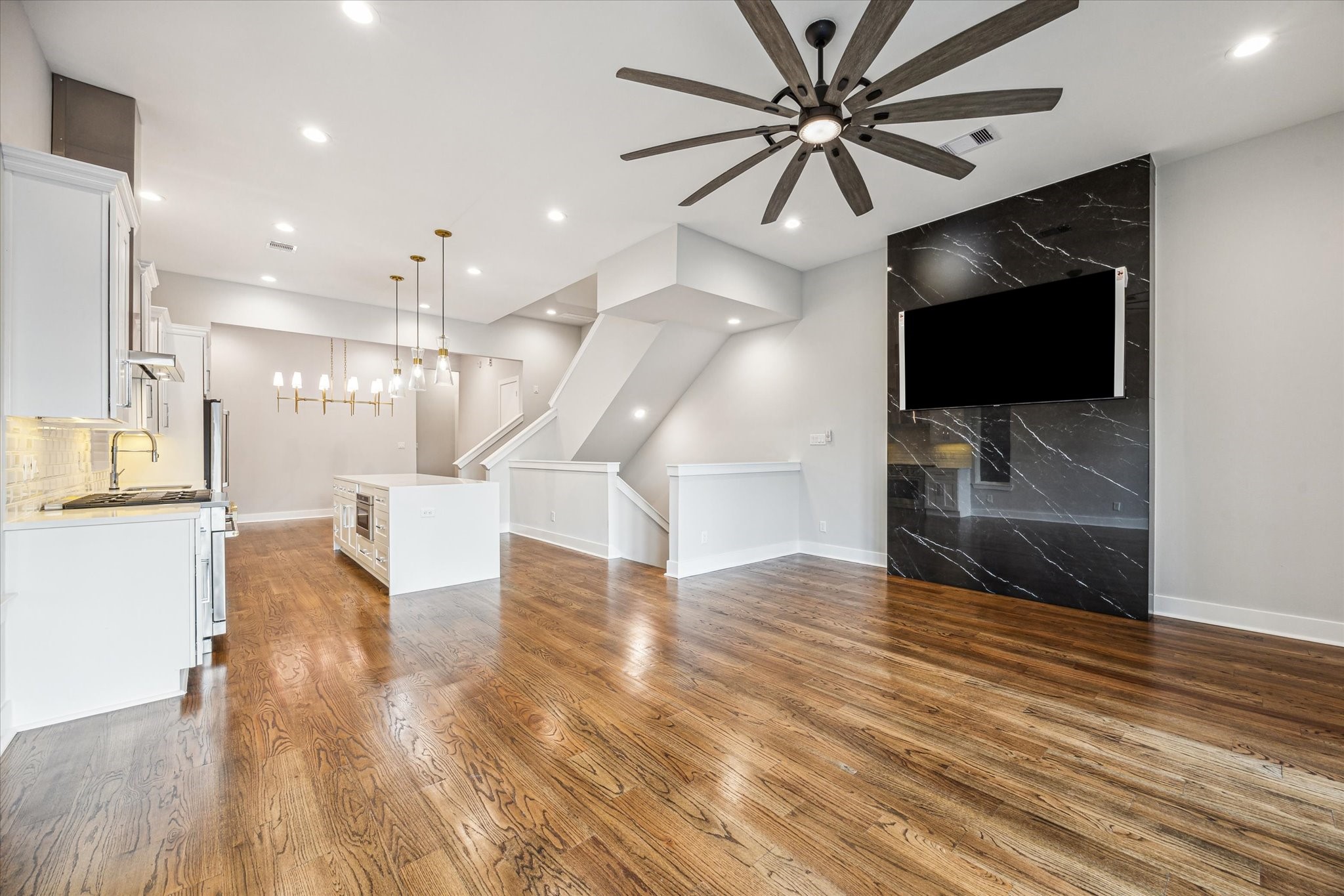 1518 Houston Avenue Houston, TX 77007 - Photo 11 of 40 a view of an empty room with wooden floor and a ceiling fan