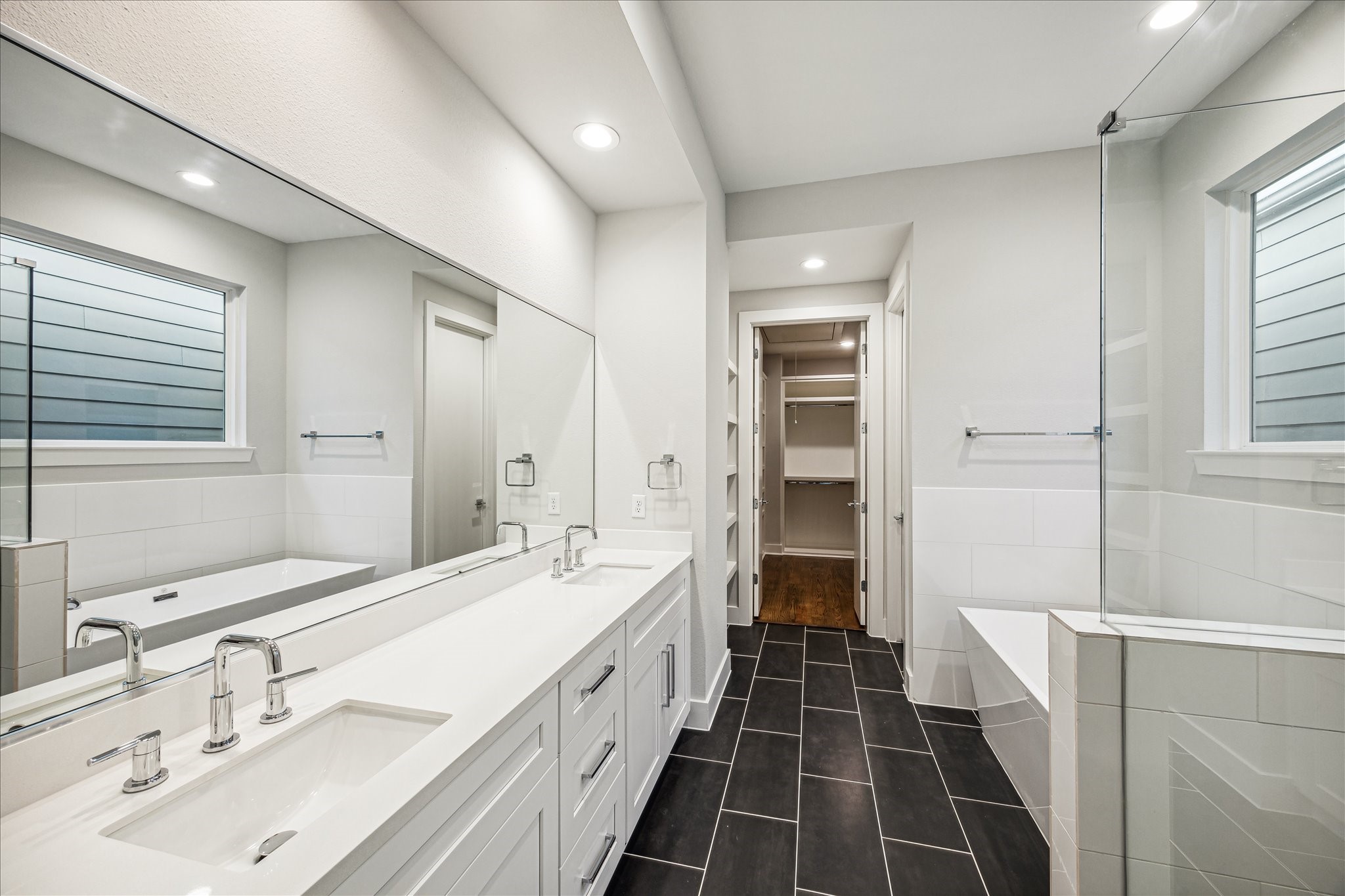1518 Houston Avenue Houston, TX 77007 - Photo 20 of 40 a bathroom with a double vanity sink a large mirror and a shower