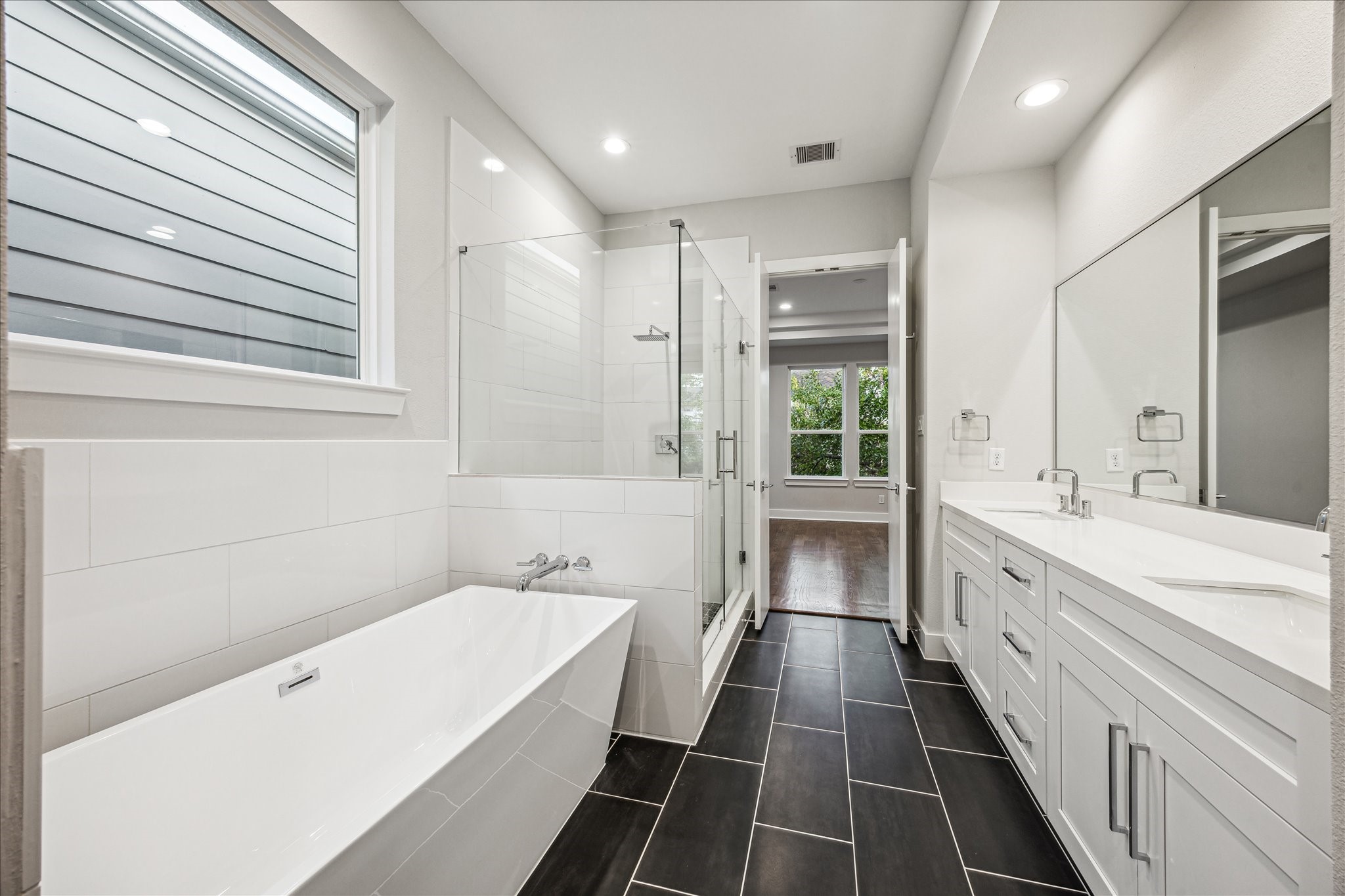 1518 Houston Avenue Houston, TX 77007 - Photo 21 of 40 a bathroom with a tub a sink and a large window