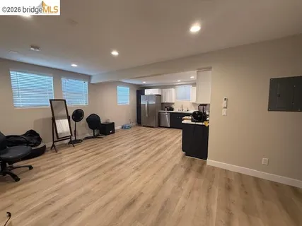 a kitchen with stainless steel appliances kitchen island granite countertop a refrigerator and a stove top oven